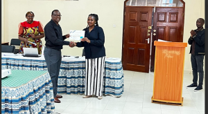 Salome Esendi receives a certificate from Dr. Willy Mwangi